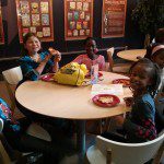 Some little theatre-goers enjoying their  pizza and friends