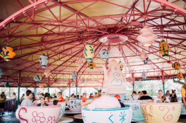 families in the teacups ride with teapot in the middle