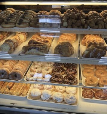 glass display of a variety of donuts