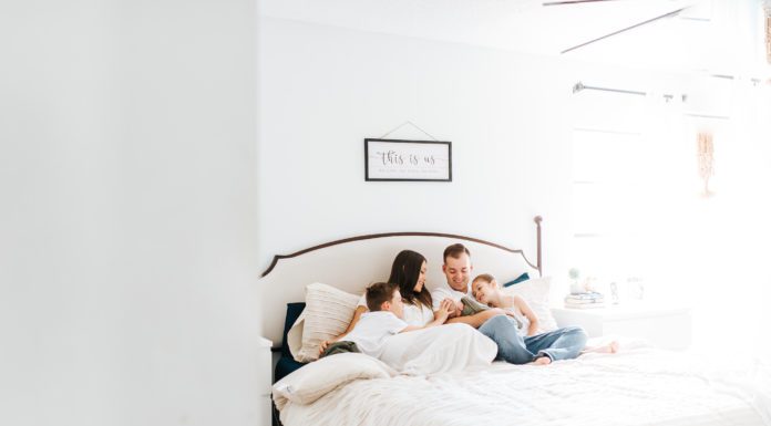 family lifestyle photography laying on bed with taupe comforter from TJMAXX
