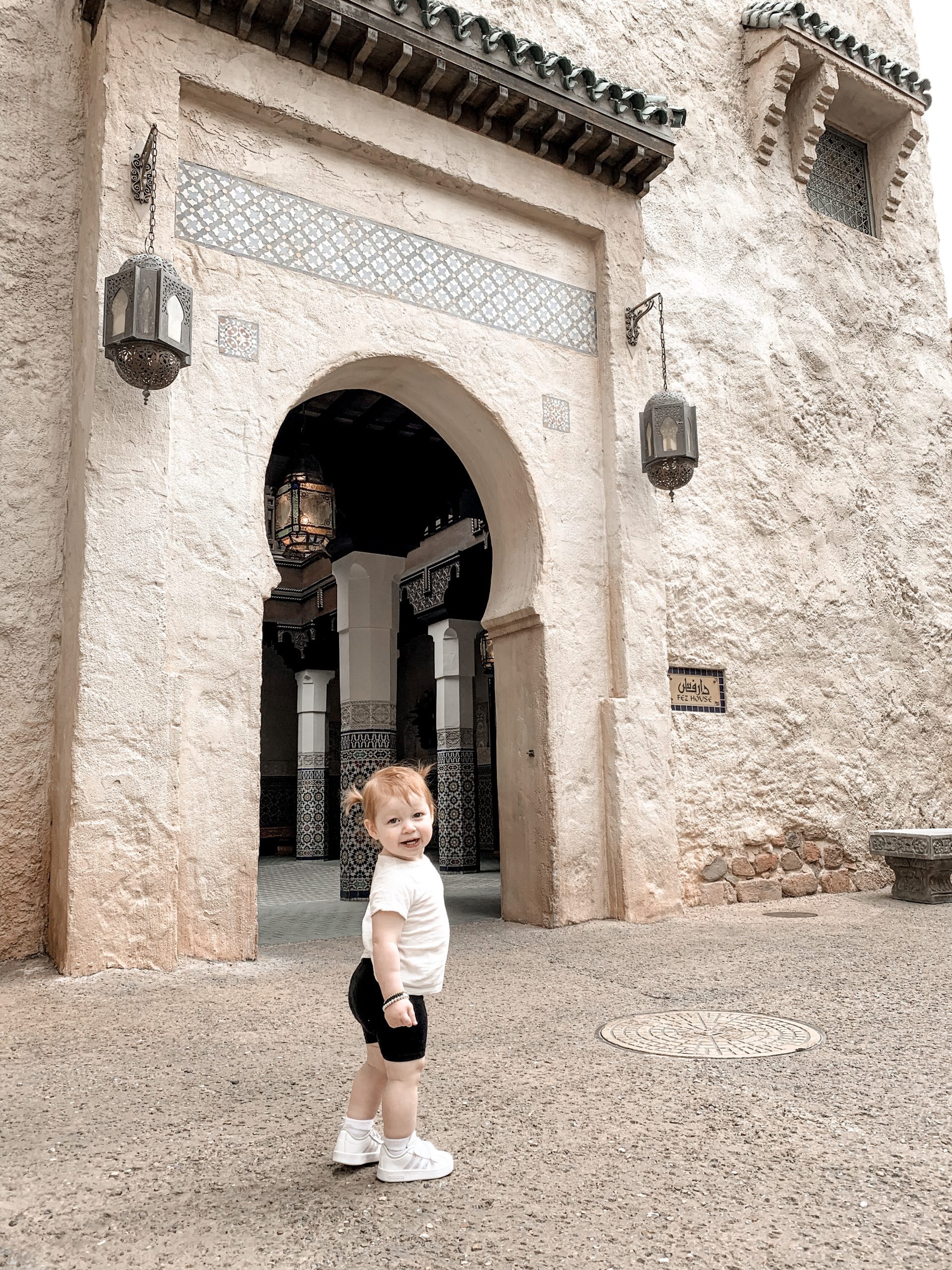 little girl walking in an empty Morocco pavilion 