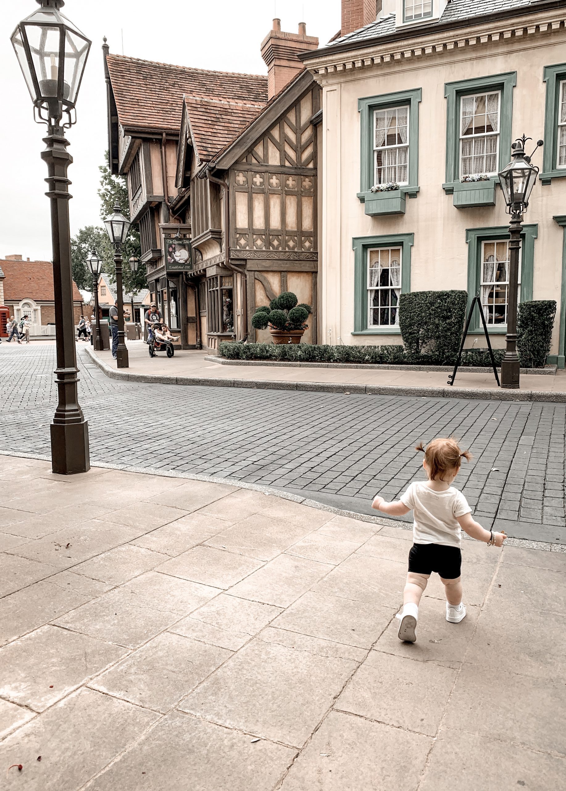 little girl walking in an empty UK pavilion at EPCOT