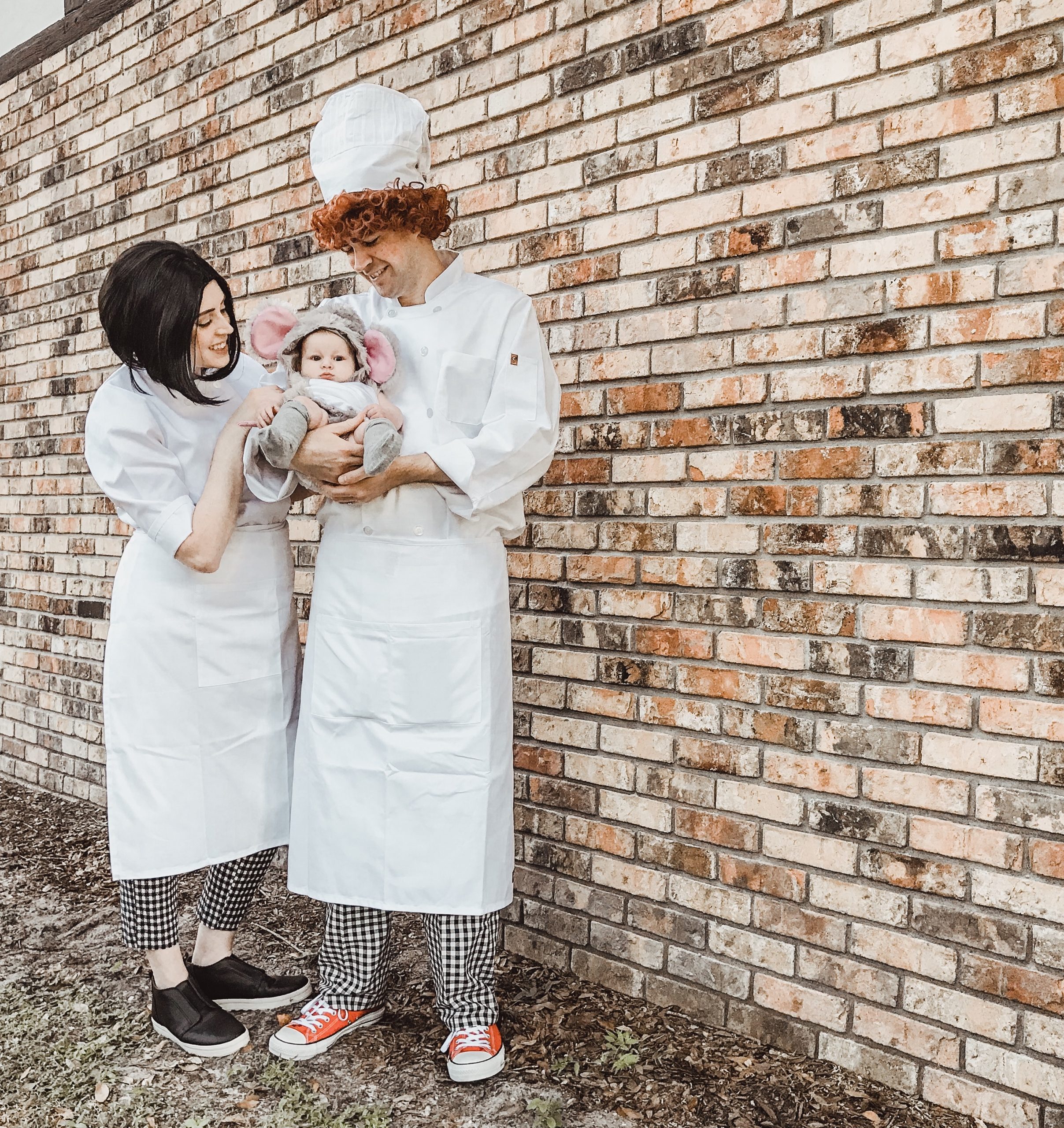 mom and dad dressed as chefs with little girl dressed as a mouse