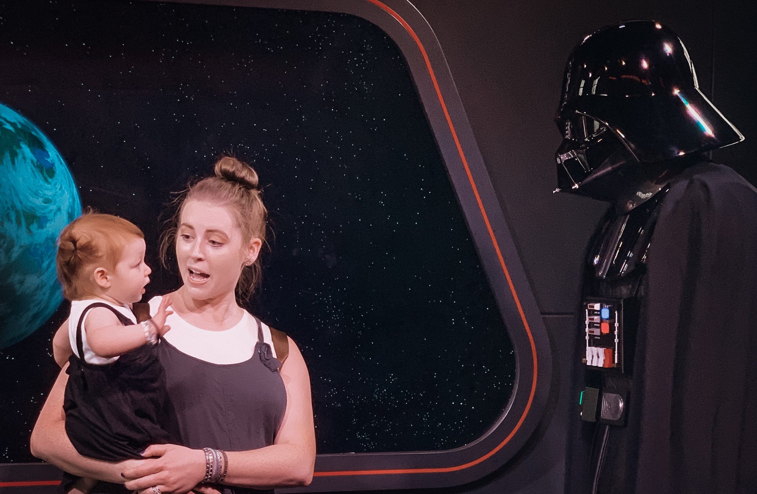 little girl and mom meeting Darth Vader