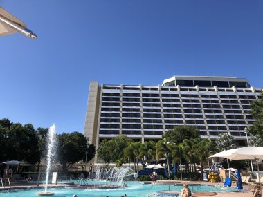 pool with fountain and hotel behind