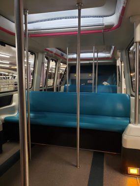 inside of a monorail with two bench seats and poles