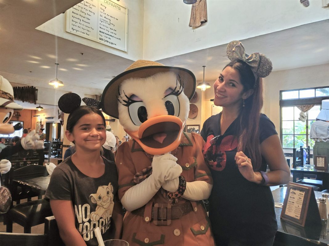 Mom and daughter with Daisy Duck at Disney's Animal Kingdom restaurant Tusker House