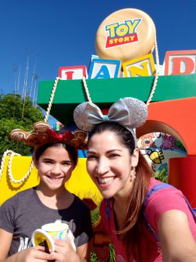 Mom and daughter smiling at Toy Story Land inside DIsney's Hollywood Studios