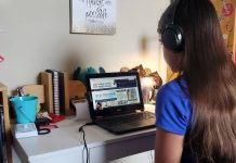 Tween girl doing virtual school on her laptop