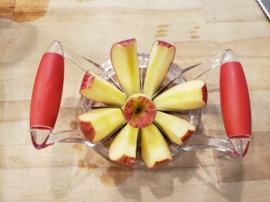 Apple slices on an apple slicer & corer