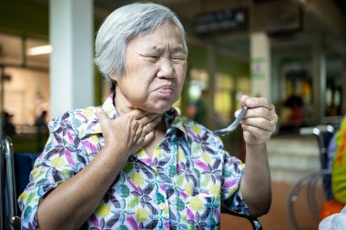 Asian senior woman suffers from choke,clogged up food,elderly pe