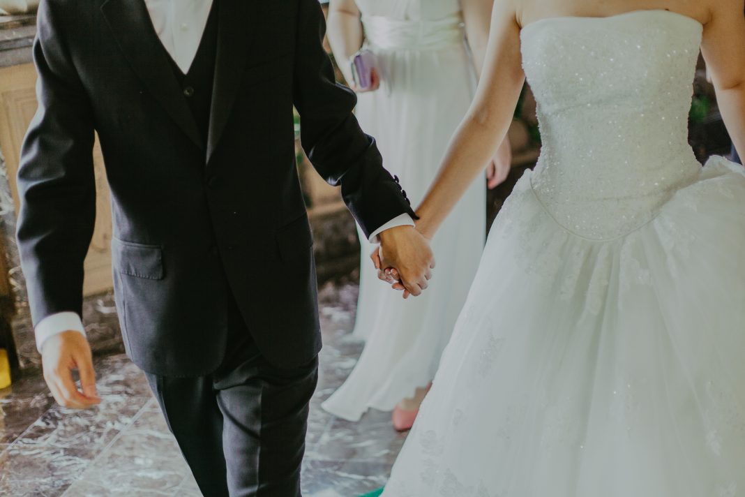 couple on wedding day holding hands