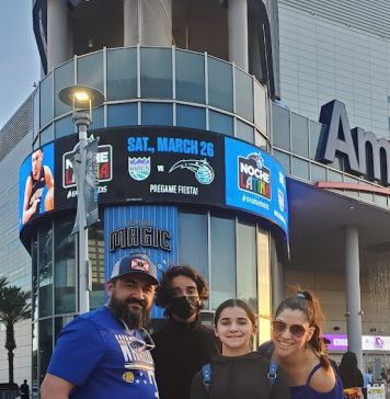 Dad, teenage son, tween daughter and mom in front of the Amway Center for an Orlando Magic NBA basketball game