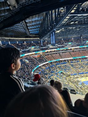 child's profile with crowd at the Kia Center behind