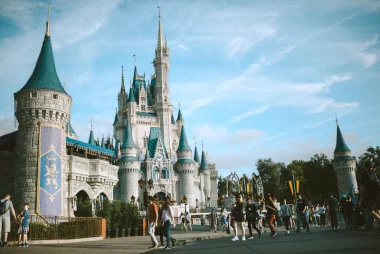 picture of cinderella castle with people walking in front of it