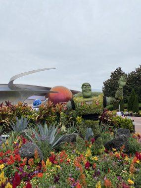 Buzz Lightyear made of flowers with Mission Space attraction behind