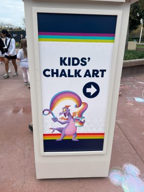 Kid's Chalk Art sing with Figment and rainbow and arrow to the right.