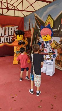 two boys meeting two lego men in costume