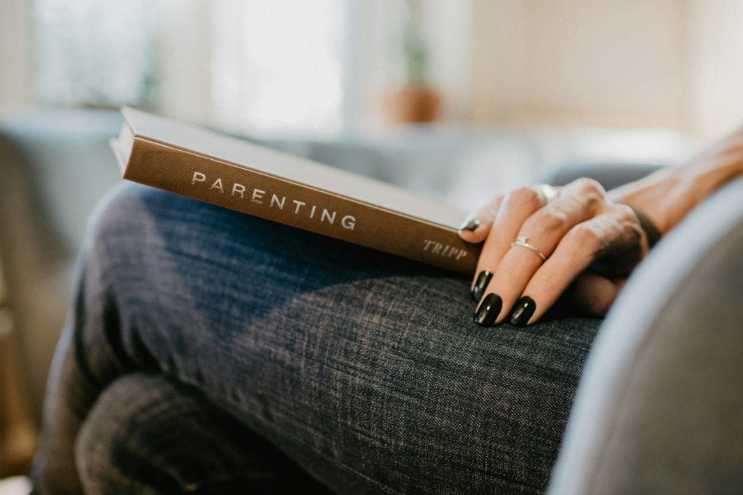 woman with parenting book on lap; breaking cycles