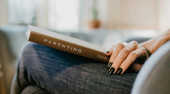 woman with parenting book on lap; breaking cycles