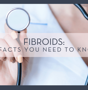 Alexandr Podvalny via unsplash phot of woman in lab coat holding up stethoscope with words 'Fibroids: 5 Facts You Need to Know'